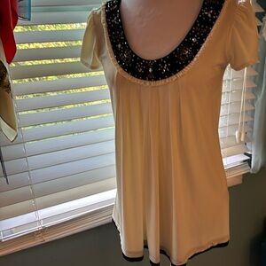 Cream color tunic with black velvety neck and hem, jewel embellishments